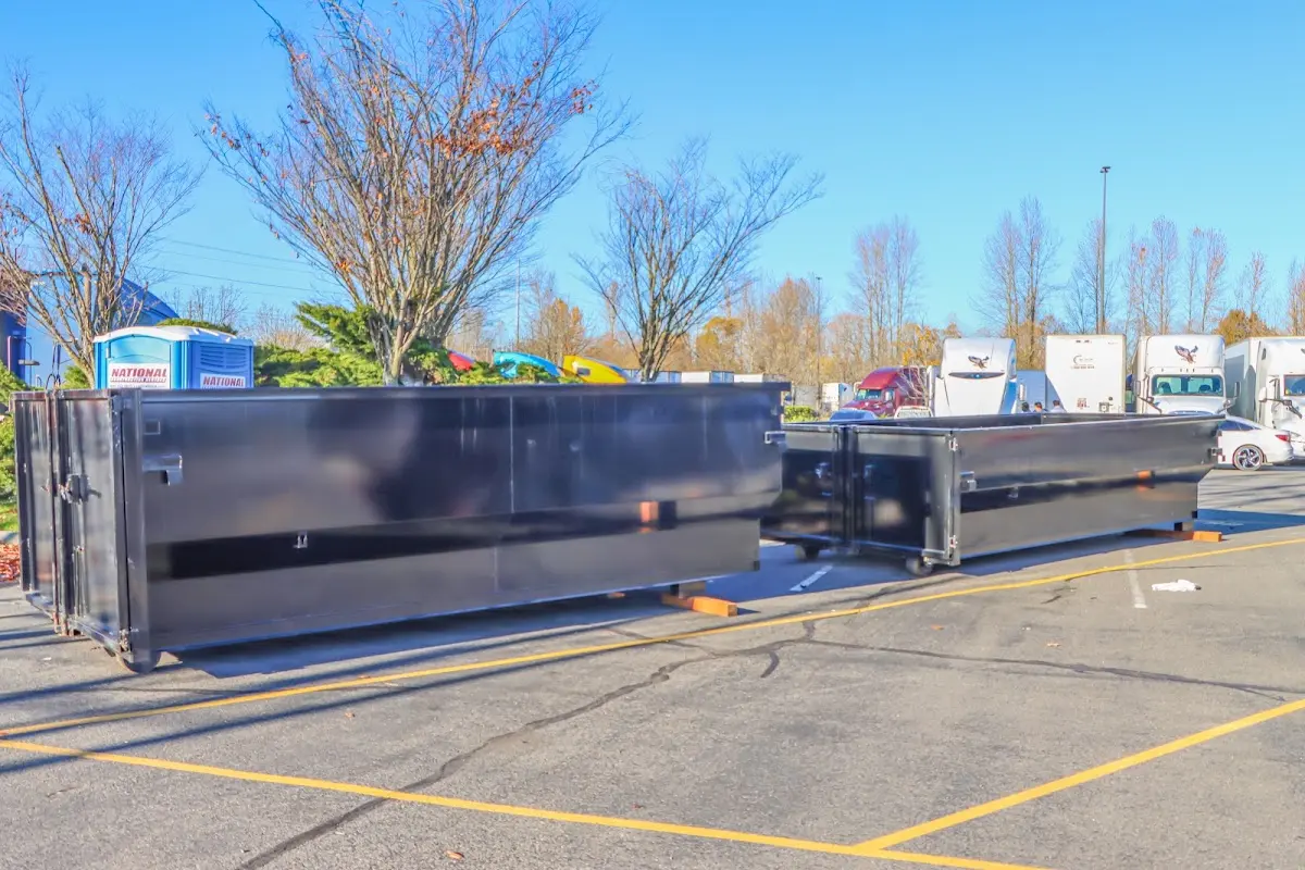 Professional dumpster rental service with roll-off container on residential driveway in Mascotte